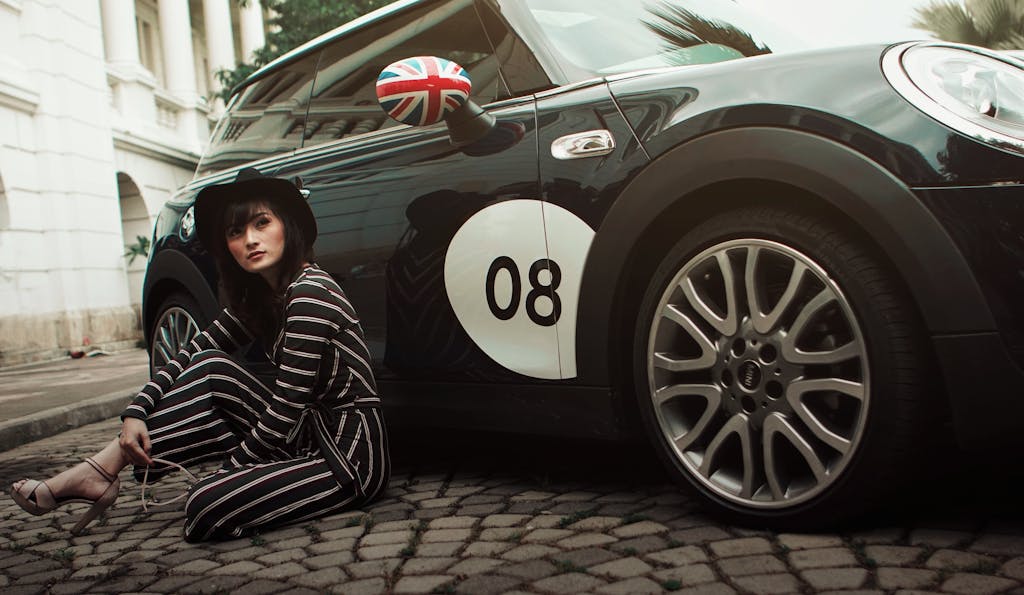 Woman Sitting Beside Car